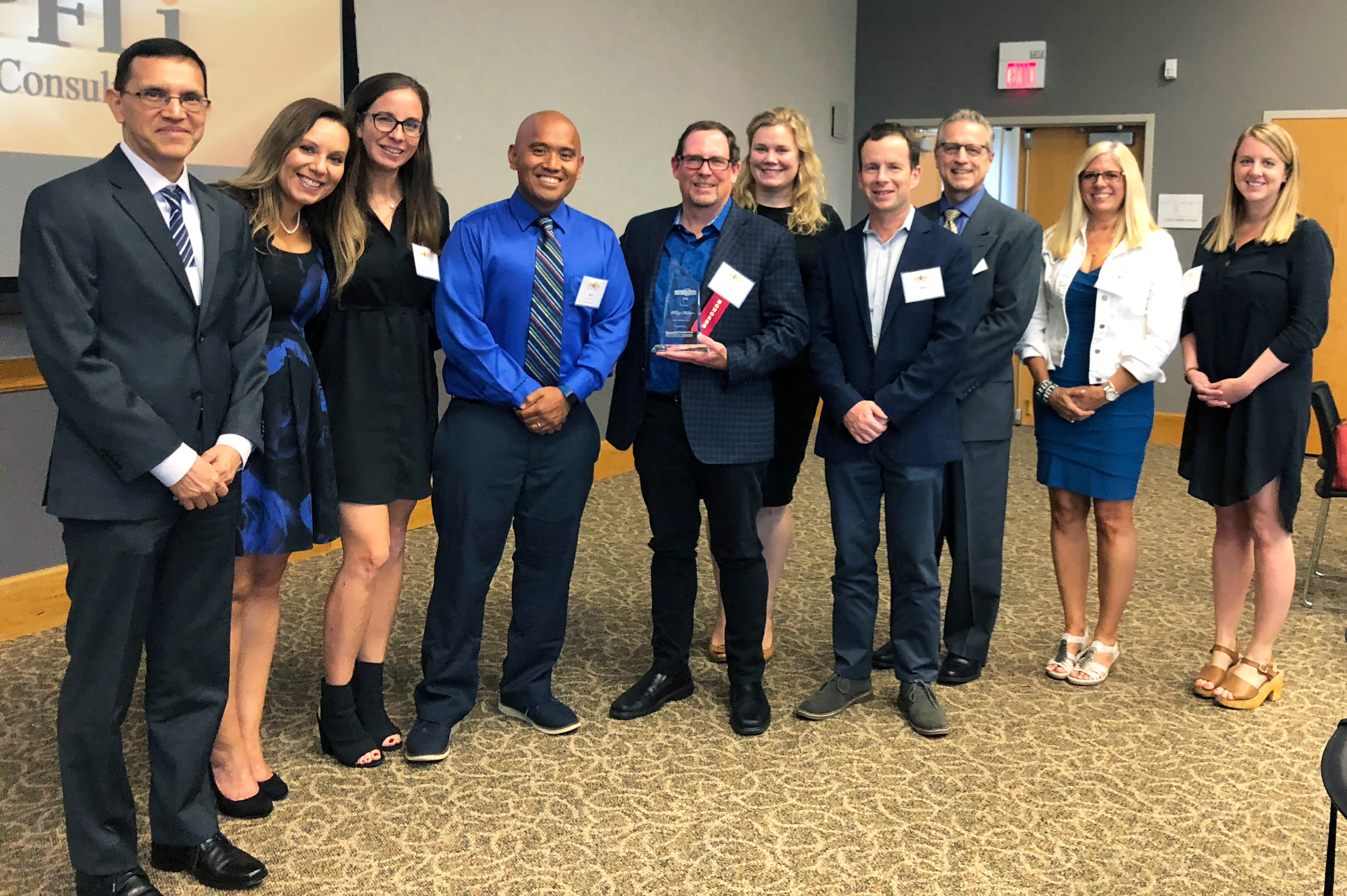 Phil Hollyer, co-founder and CEO of Bounteous, sports his C-Suite of the Year award surrounded by colleagues at the awards reception on Thursday, July 26 in Naperville, IL. 